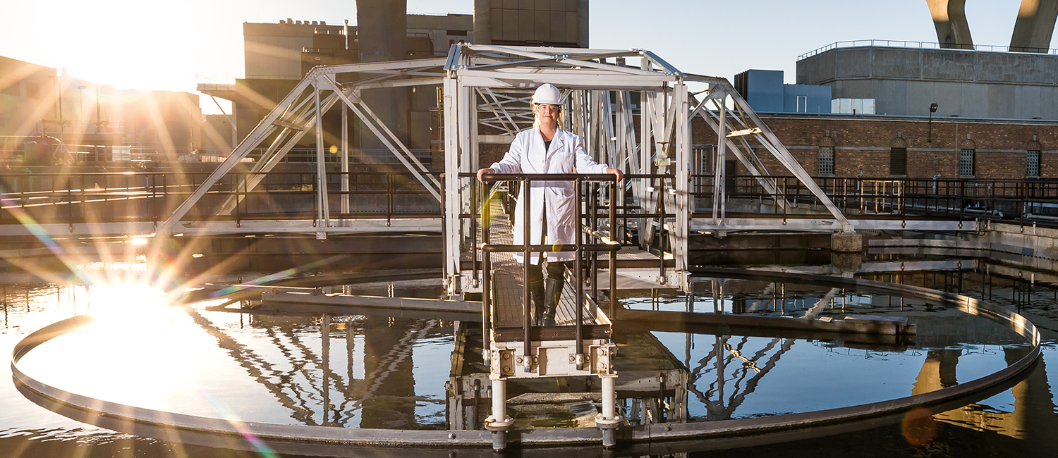 University of Wisconsin Milwaukee professor, Sandra McLellan, standing on a metal walkway above one of the clarifiers at the Milwaukee Metropolitan Sewerage District’s Jones Island treatment facility.